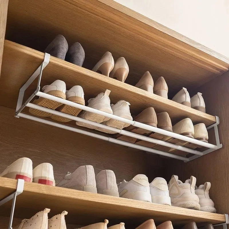 Adjustable telescopic shoe rack with hanging basket for space-saving shoe storage in wardrobe, made of carbon steel.