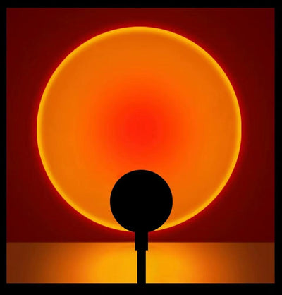 LED Sunset Lamp projecting warm orange sunset glow on wall with USB powered mood lighting and adjustable angles