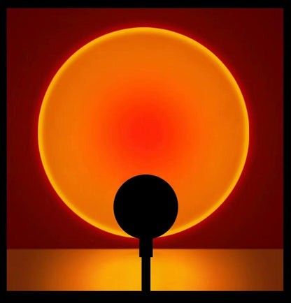 LED Sunset Lamp projecting warm orange sunset glow on wall with USB powered mood lighting and adjustable angles
